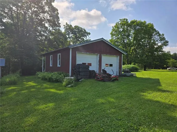 a view of a house with a yard and sitting area