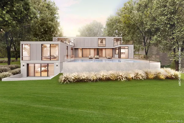 a white house with a big yard and large trees