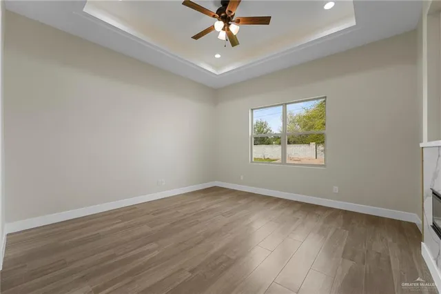 a room with a fireplace and a wooden floor