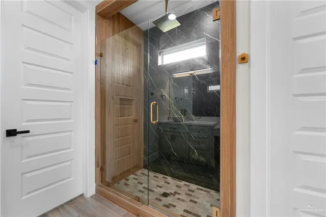 a room with walk in closet and wooden floor