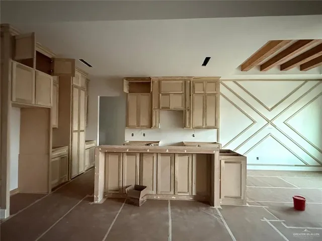 a kitchen with stainless steel appliances kitchen island granite countertop a refrigerator and a sink