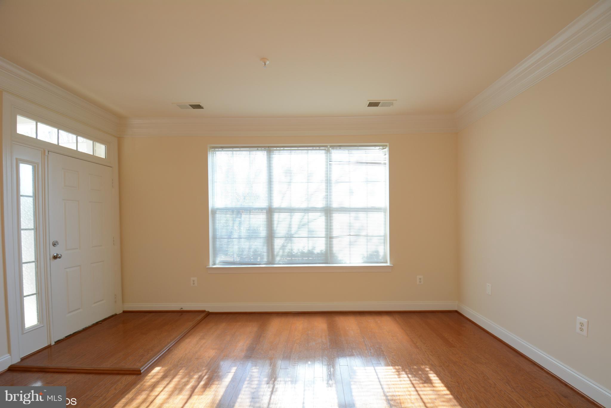 4110 Potomac Highlands Circle, Unit 5 Triangle, VA 22172 - Photo 2 of 24 an empty room with wooden floor and windows