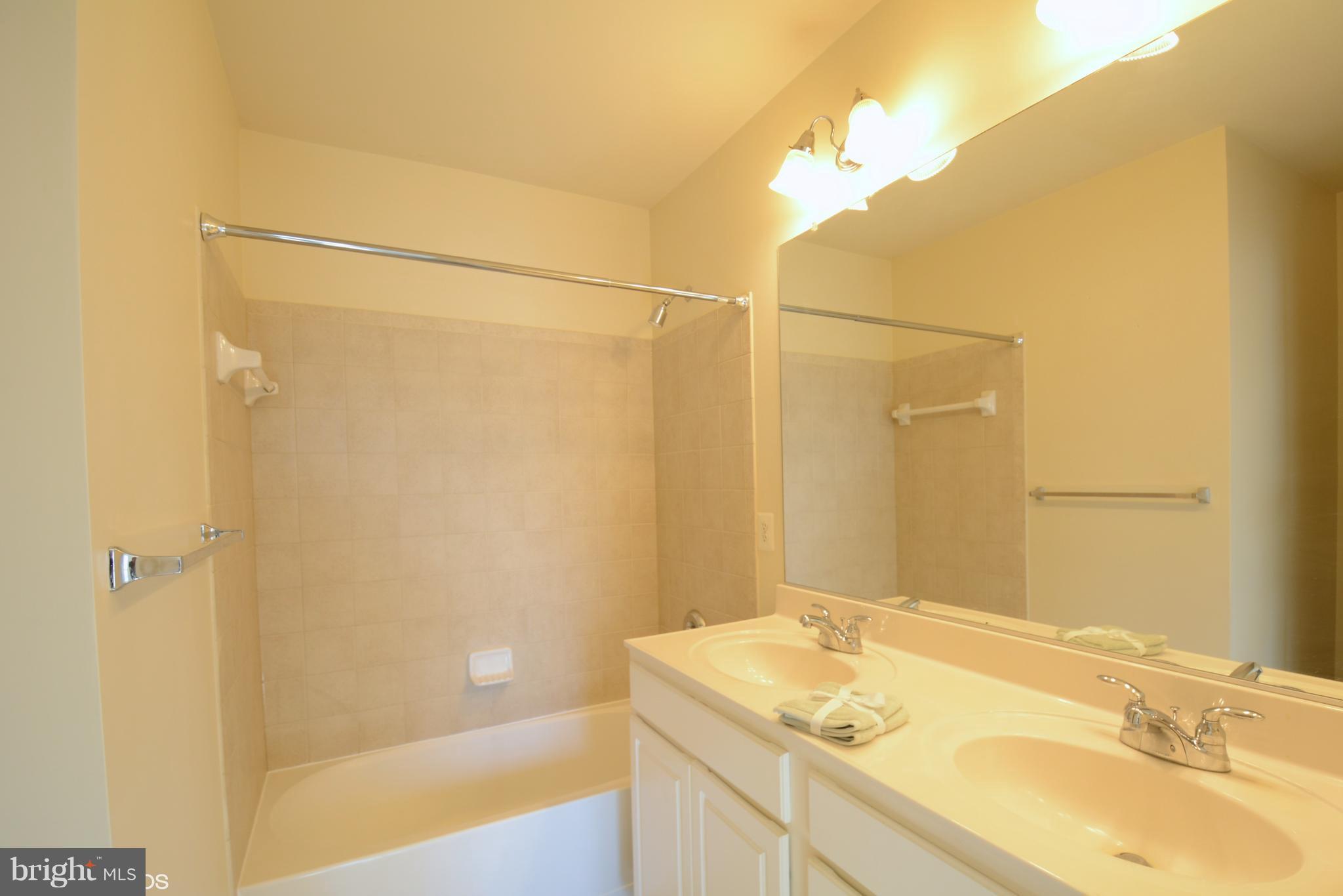 4110 Potomac Highlands Circle, Unit 5 Triangle, VA 22172 - Photo 15 of 24 a bathroom with a granite countertop sink and a mirror