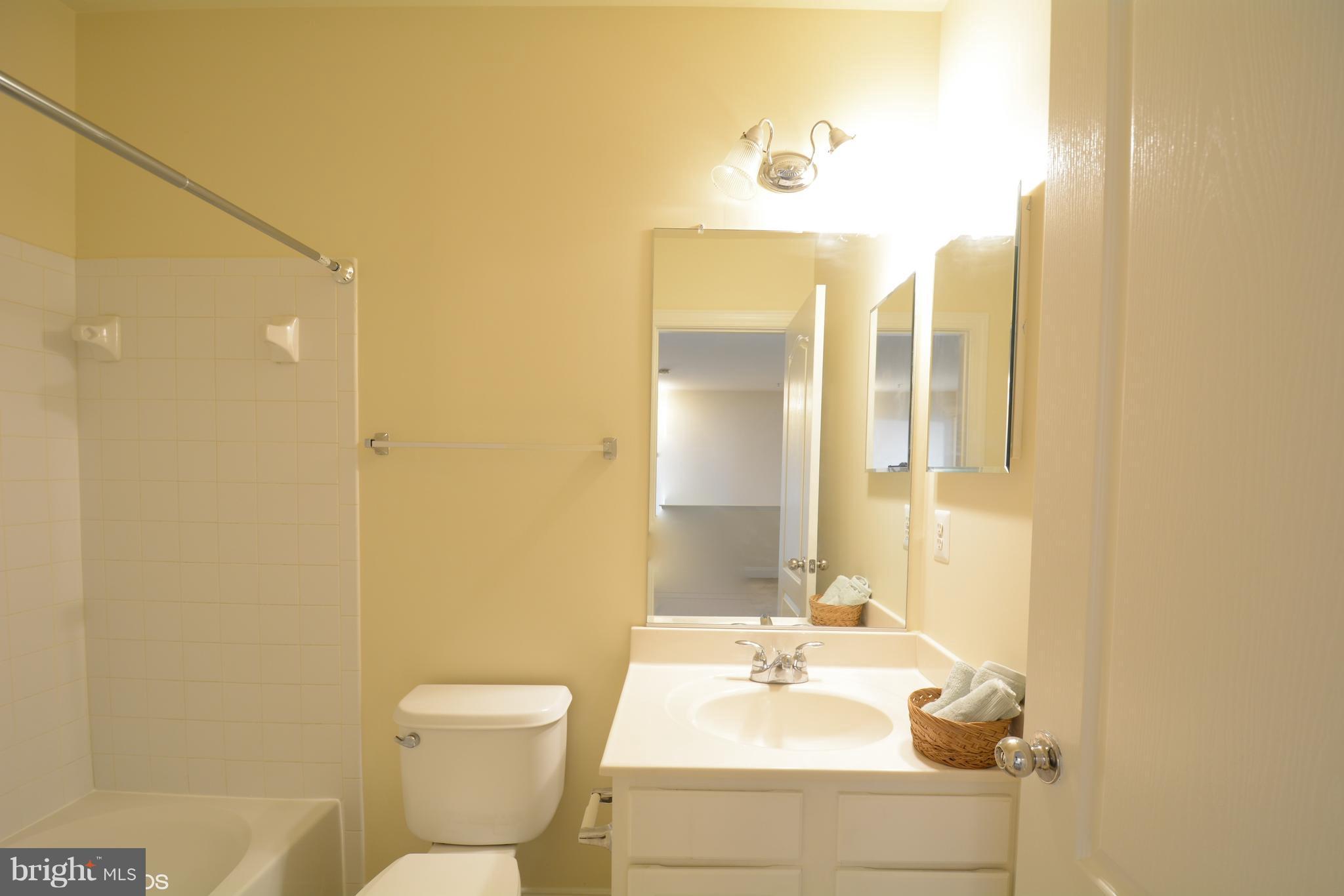 4110 Potomac Highlands Circle, Unit 5 Triangle, VA 22172 - Photo 19 of 24 a bathroom with a sink mirror toilet and shower
