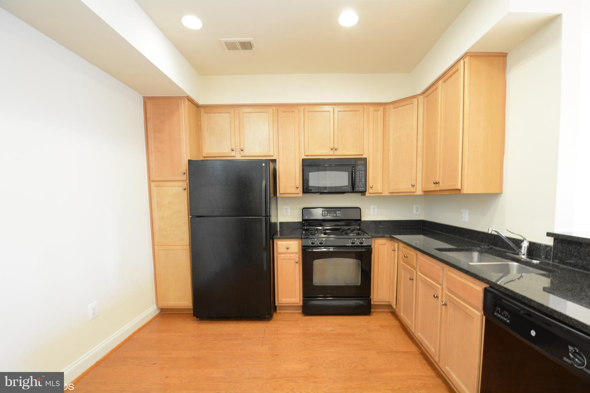 4110 Potomac Highlands Circle, Unit 5 Triangle, VA 22172 - Photo 7 of 24 a kitchen with a refrigerator sink and stove