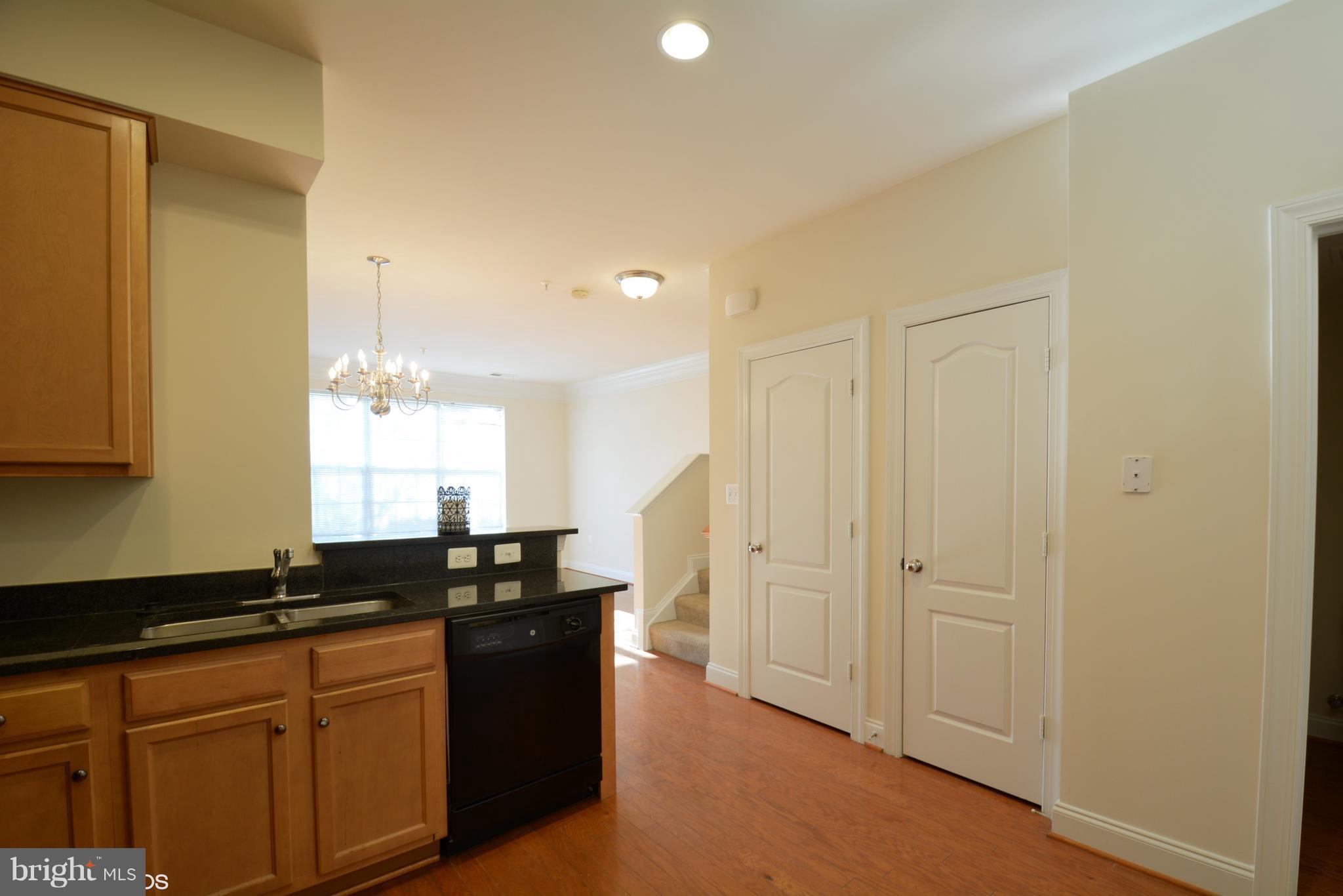 4110 Potomac Highlands Circle, Unit 5 Triangle, VA 22172 - Photo 9 of 24 a kitchen with granite countertop a sink and cabinets