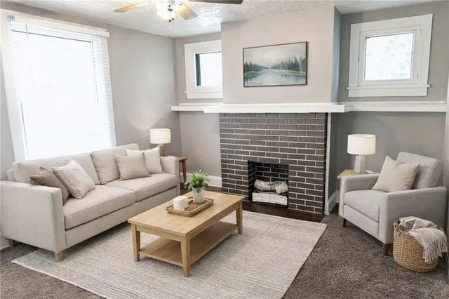 a living room with furniture and a fireplace