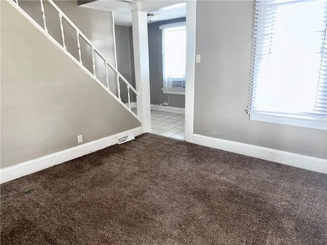 a view of an empty room with stairs