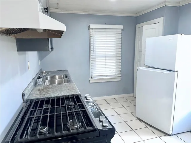 a stove top oven sitting inside of a kitchen