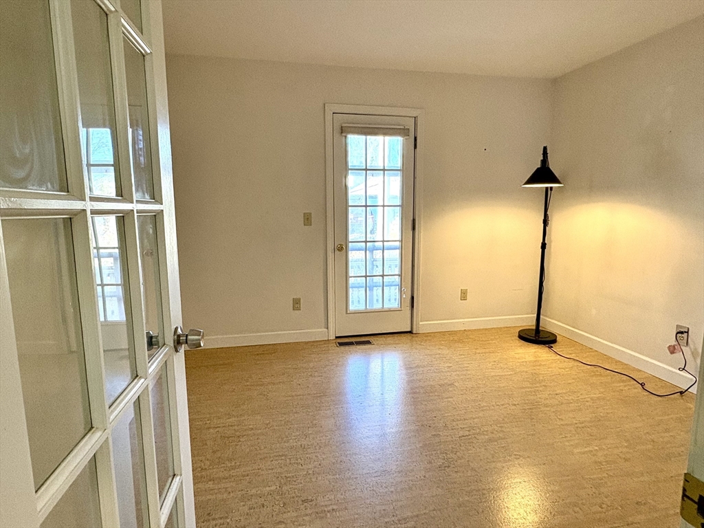 9 Walnut Street, Unit B Northampton, MA 01060 - Photo 16 of 25 an empty room with wooden floor and windows
