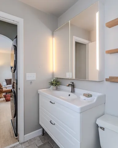 a bathroom with a sink toilet and mirror