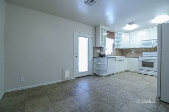 1043 Peg Street Ridgecrest, CA 93555 - Photo 10 of 45 a kitchen with a cabinets and white appliances