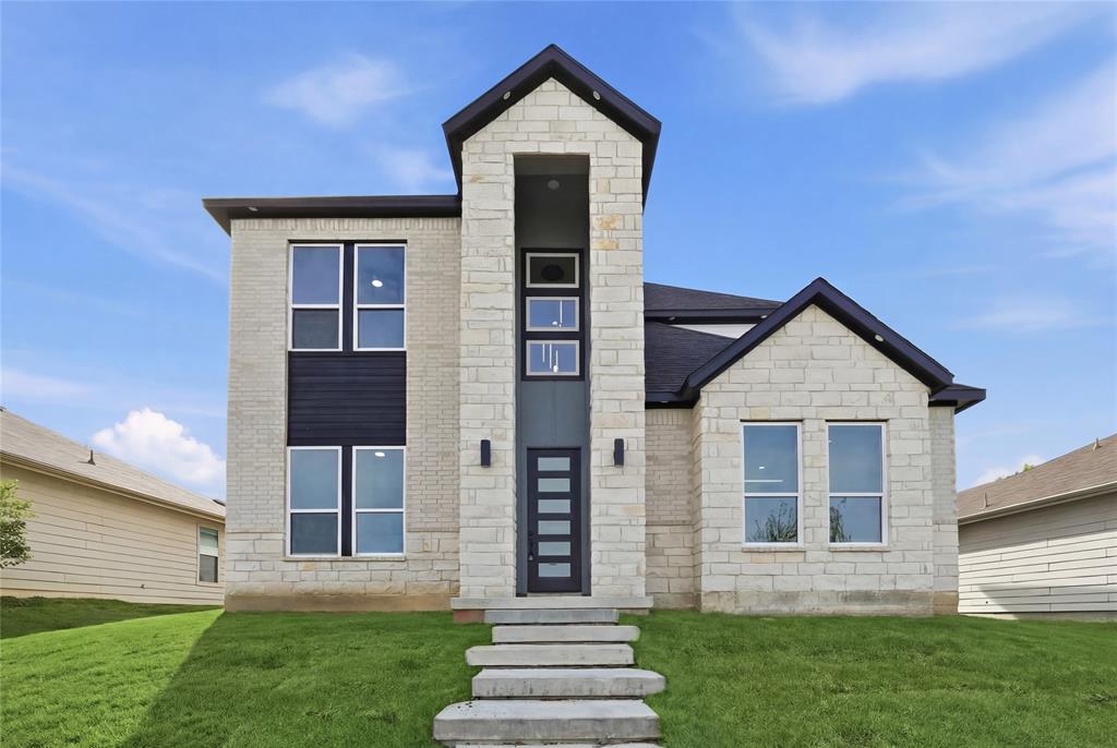 Contemporary house featuring stone siding and a front lawn