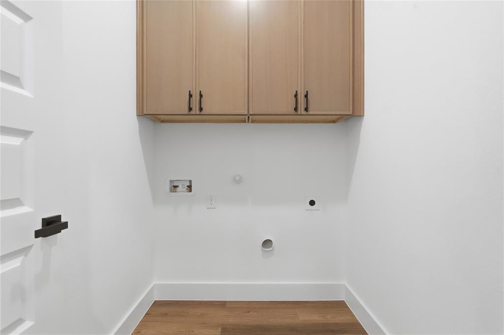 7817 Red Spring Road Dallas, TX 75241 - Photo 10 of 23 Laundry room featuring gas dryer hookup, light wood finished floors, washer hookup, and cabinet space
