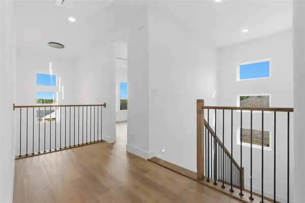 a view of a hallway with wooden floor