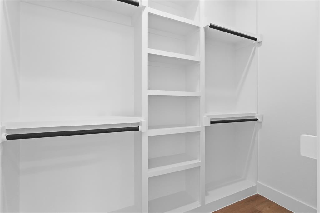 7817 Red Spring Road Dallas, TX 75241 - Photo 20 of 23 Walk in closet with dark wood-style flooring