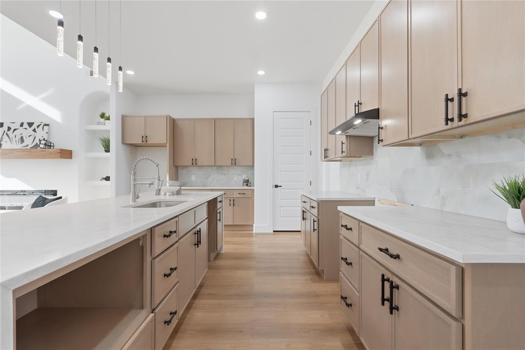 7817 Red Spring Road Dallas, TX 75241 - Photo 6 of 23 Kitchen featuring light wood finish cabinets, light wood finished floors, pendant lighting, and light stone countertops