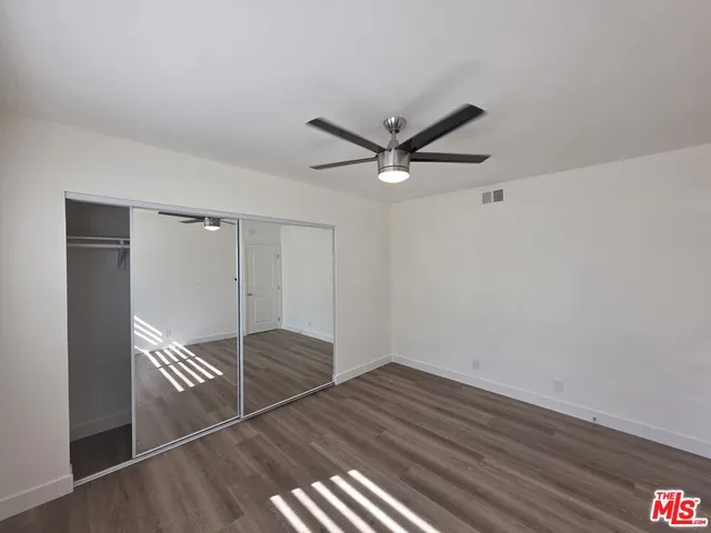 a bathroom with a granite countertop toilet a sink and shower