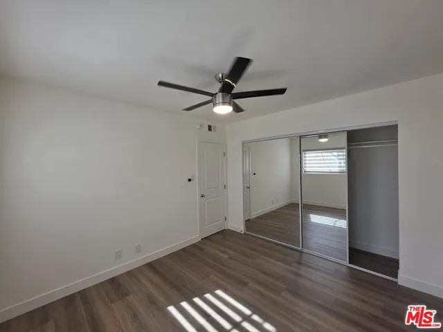 a view of walk in closet with wooden floor