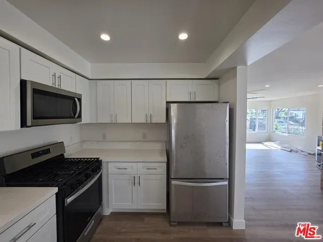 a view of room with wooden floor
