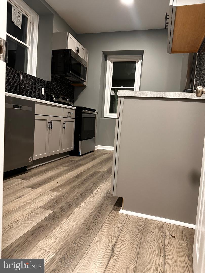 32 Kent Road Upper Darby, PA 19082 - Photo 18 of 60 a kitchen with stainless steel appliances a refrigerator and a stove top oven