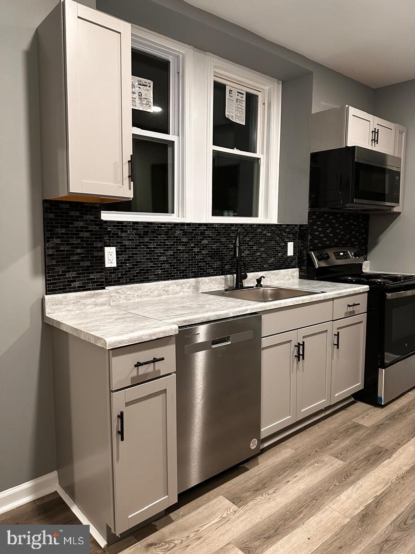 32 Kent Road Upper Darby, PA 19082 - Photo 19 of 60 a kitchen with a sink and stainless steel appliances