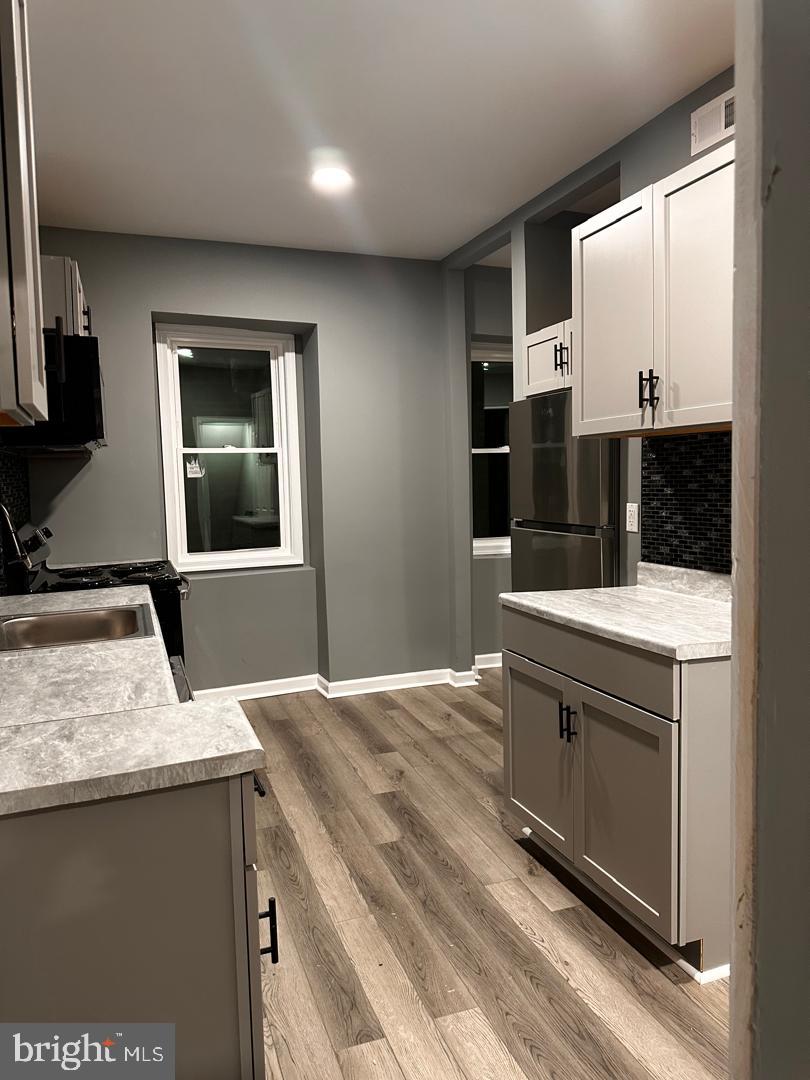 32 Kent Road Upper Darby, PA 19082 - Photo 20 of 60 a kitchen with stainless steel appliances wooden cabinets and a sink