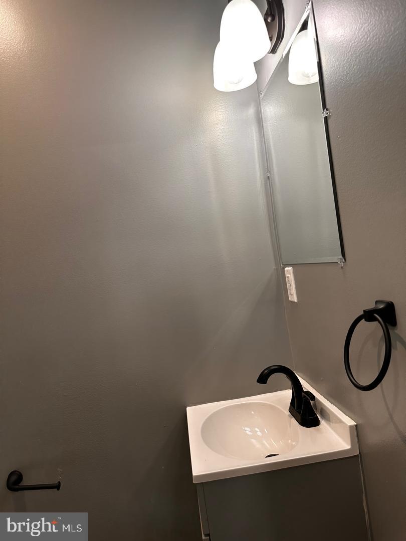 32 Kent Road Upper Darby, PA 19082 - Photo 24 of 60 a bathroom with a sink and a mirror