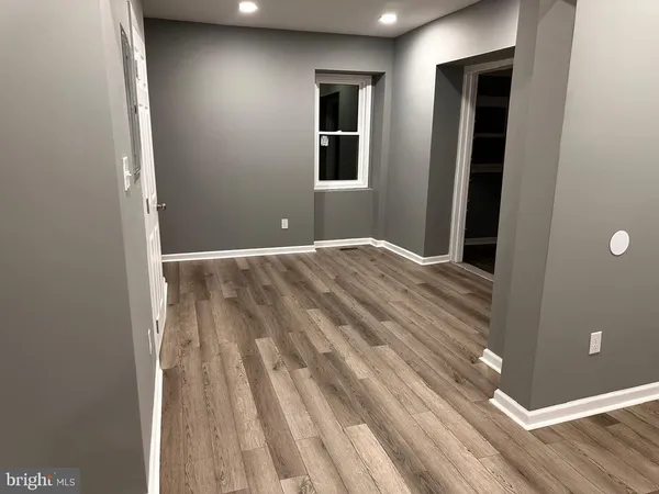 a view of a room with wooden floor and more window
