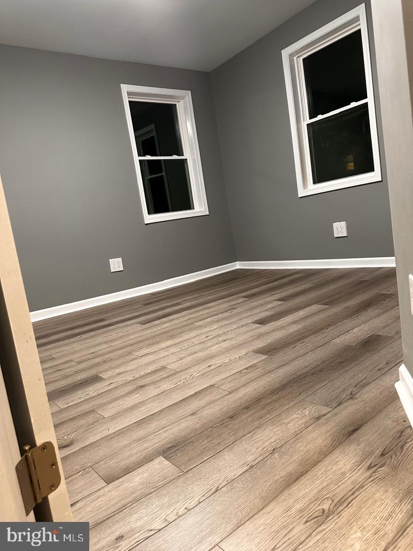 32 Kent Road Upper Darby, PA 19082 - Photo 38 of 60 a view of an empty room with wooden floor and windows