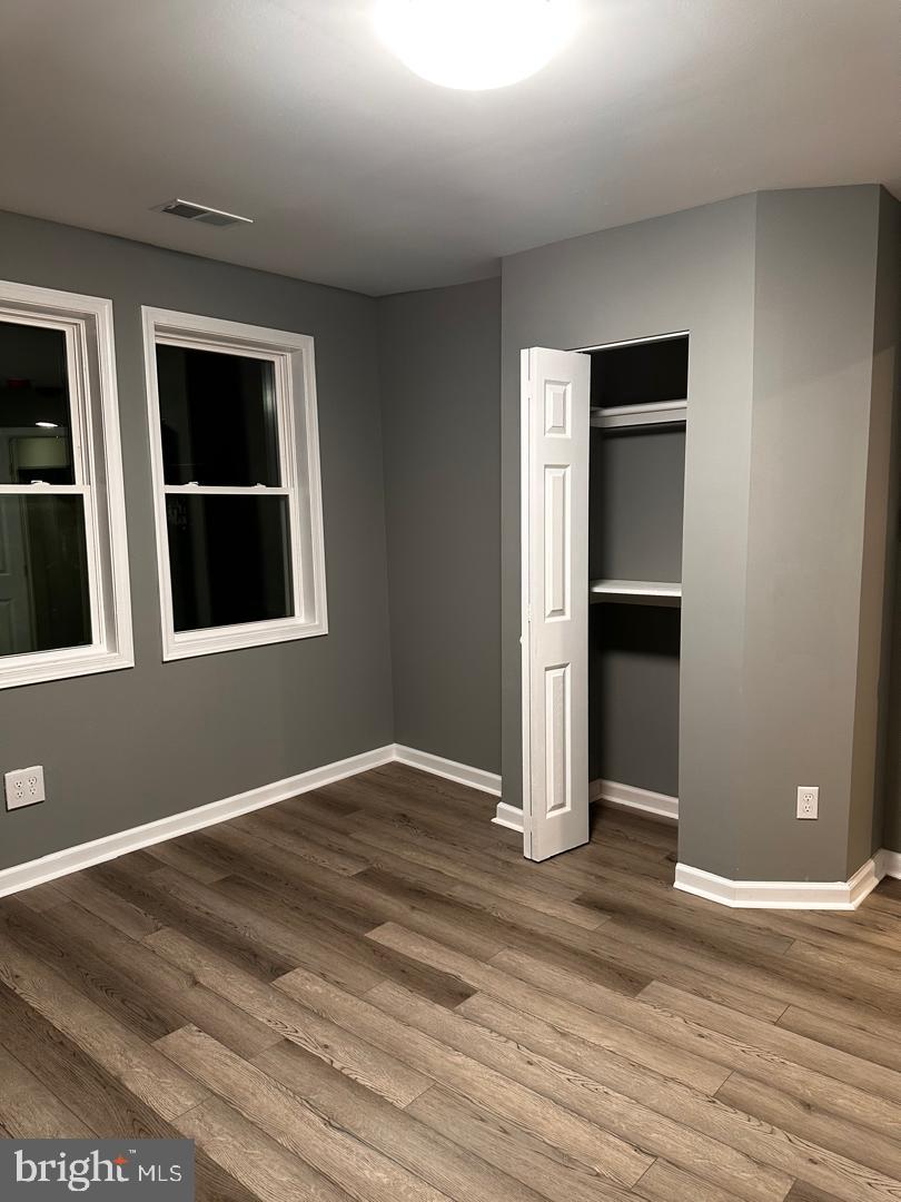 32 Kent Road Upper Darby, PA 19082 - Photo 40 of 60 a view of an empty room with wooden floor and windows
