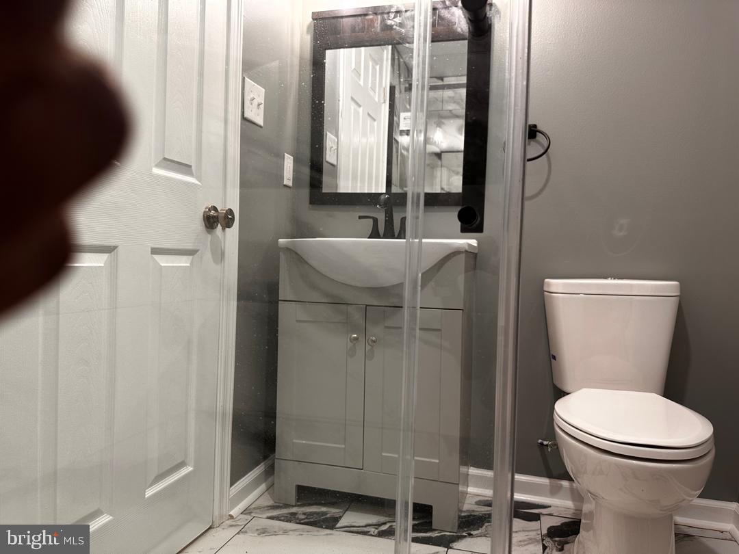 32 Kent Road Upper Darby, PA 19082 - Photo 57 of 60 a bathroom with a toilet a sink and shower