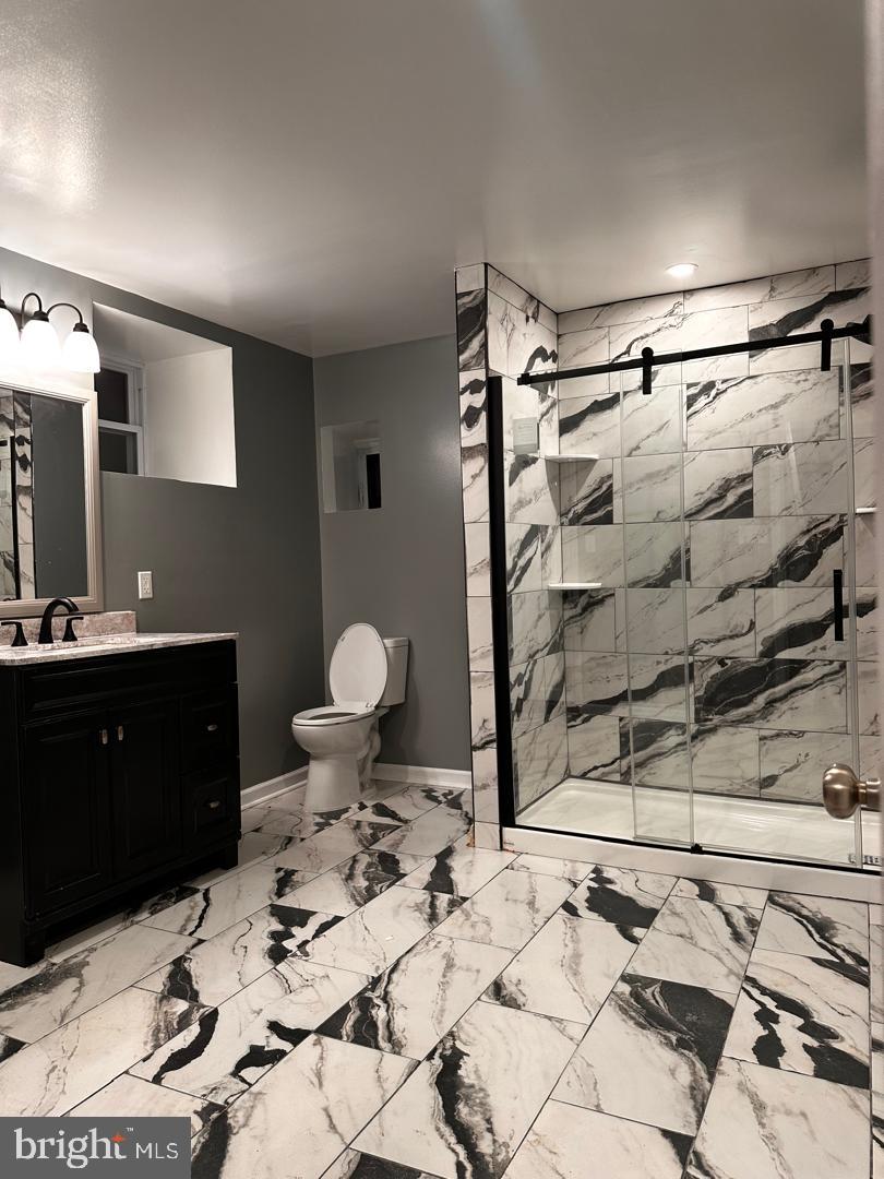 32 Kent Road Upper Darby, PA 19082 - Photo 6 of 60 a bathroom with a sink mirror vanity and toilet