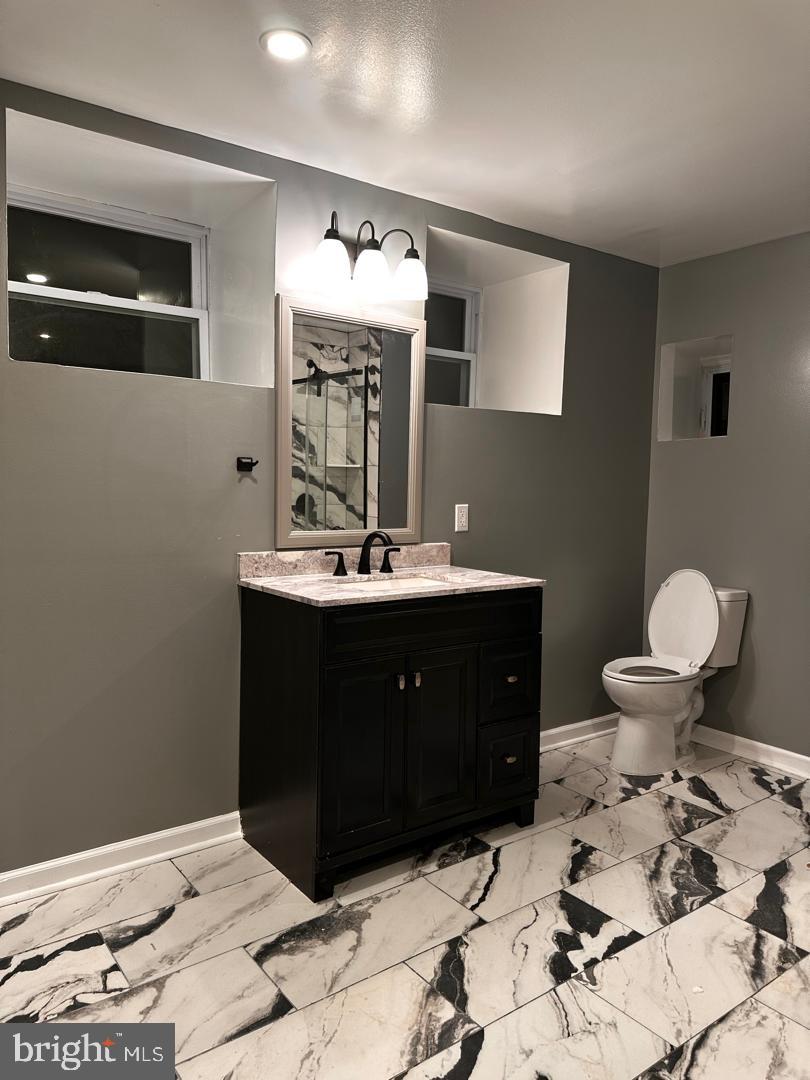 32 Kent Road Upper Darby, PA 19082 - Photo 8 of 60 a bathroom with a sink and a mirror