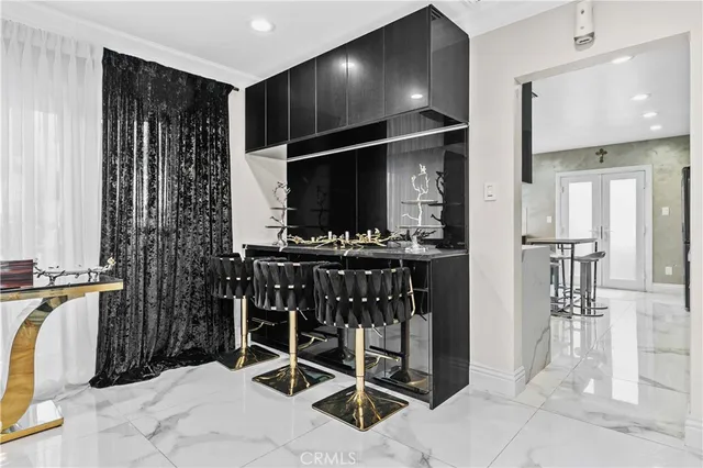 a kitchen with stainless steel appliances kitchen island granite countertop a refrigerator and a sink