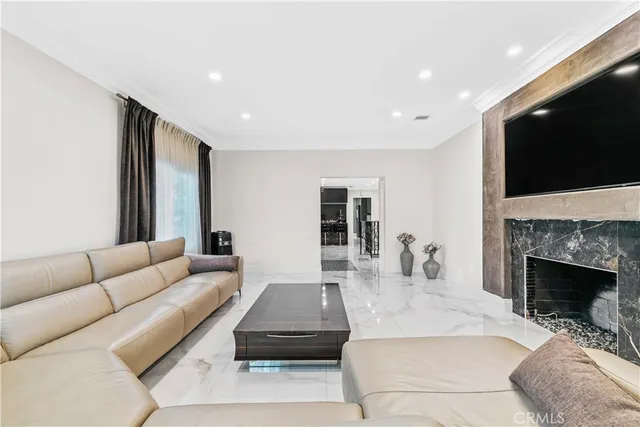 a living room with furniture fireplace and flat screen tv