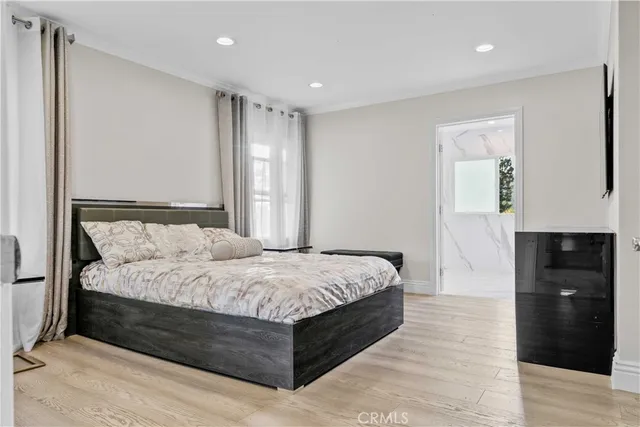 a spacious bedroom with a bed and a dresser