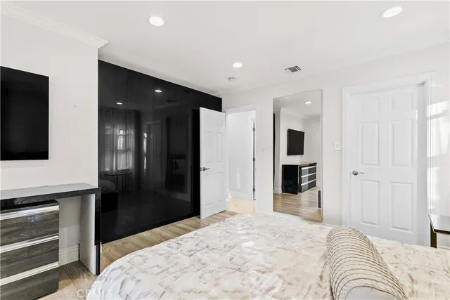 a bed room with a bed and a television