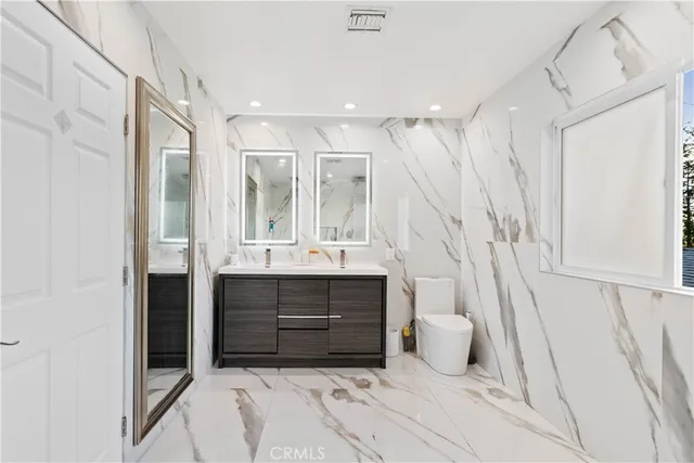a bathroom with a double vanity sink and mirror