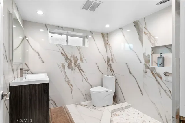 a bedroom with a bed and cabinets