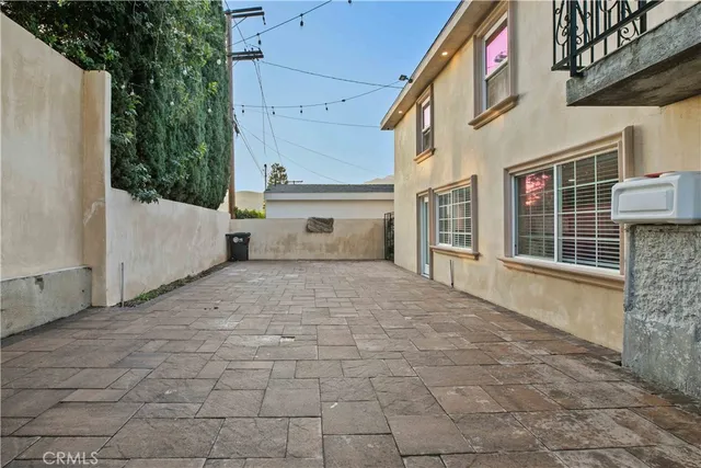 a view of a patio with table and chairs and potted plants