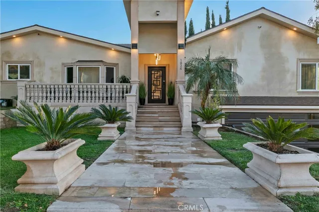 a front view of a house with garden