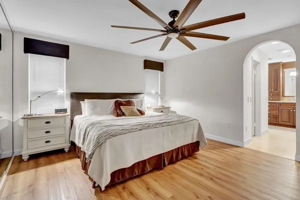 a bedroom with a bed and a ceiling fan