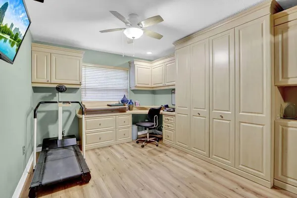 a view of a workspace with furniture and a window