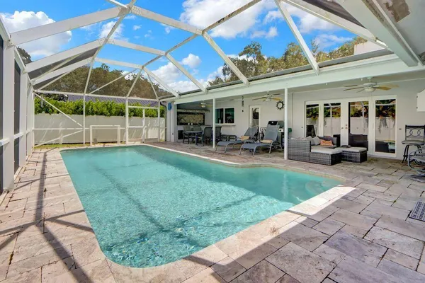 a view of a backyard with table and chairs under an umbrella