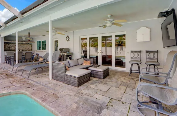 a building outdoor space with patio furniture and potted plants