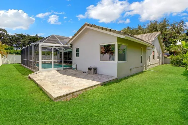 a view of a house with a backyard