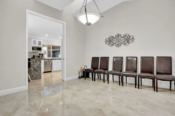 a view of kitchen with furniture and refrigerator