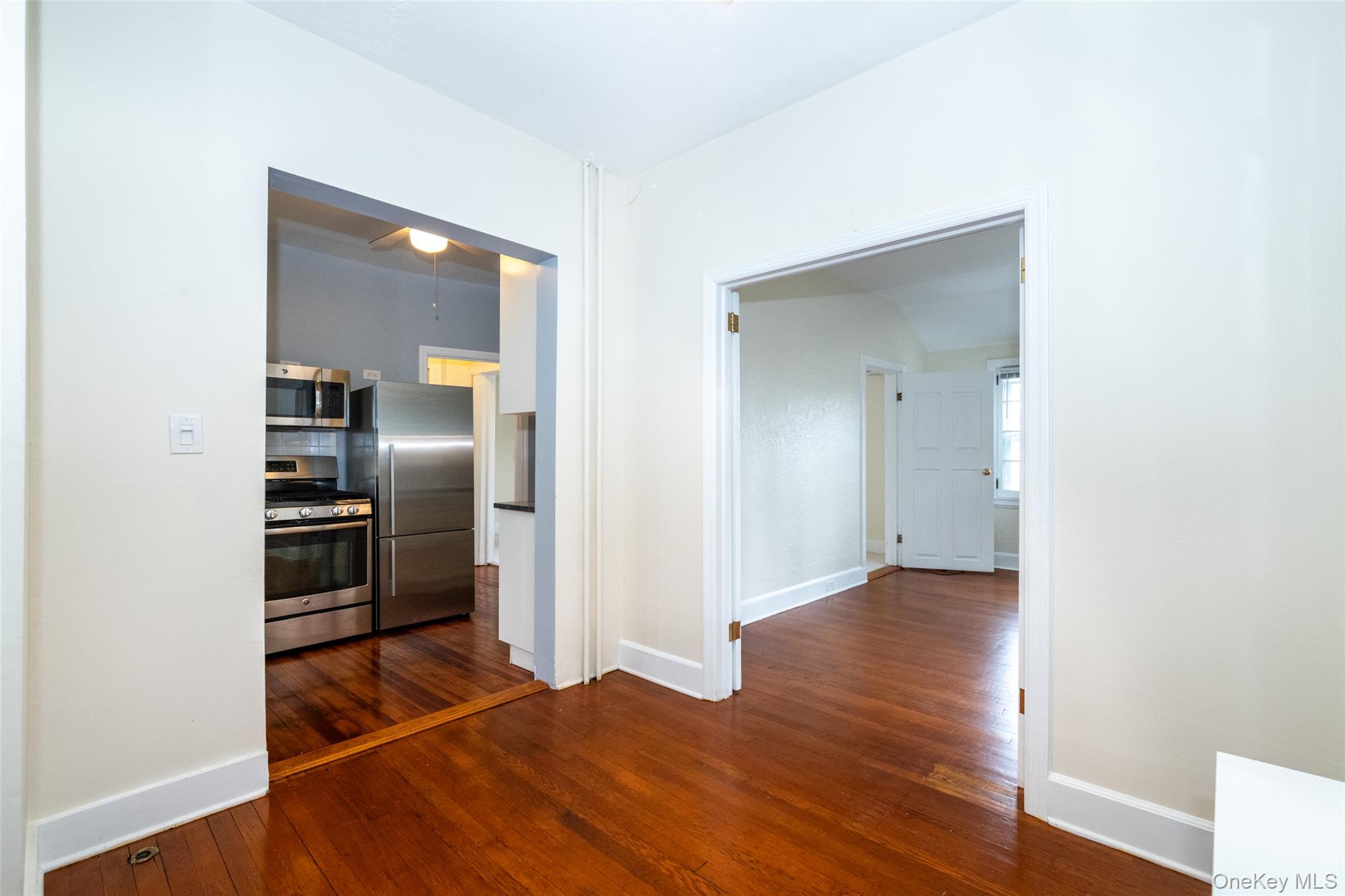82 Clove Road New Rochelle, NY 10801 - Photo 17 of 39 a view of kitchen with refrigerator and wooden floor