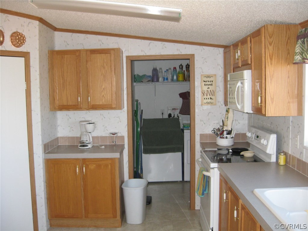 48 Reservoir Road Victoria, VA 23974 - Photo 8 of 26 a kitchen with a sink a refrigerator and cabinets